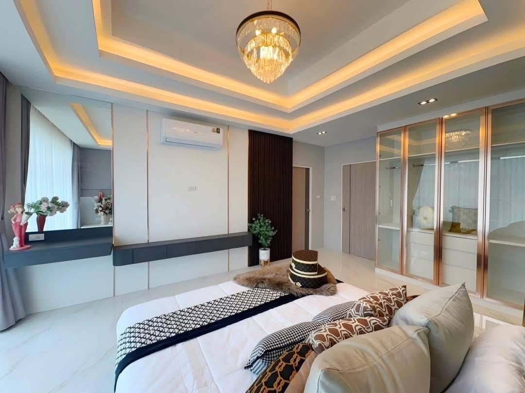 Pool Villa Central Park 4-2 (11) Modern luxury bedroom with tray ceiling, chandelier, and glass wardrobe doors