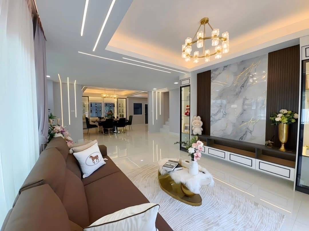 Pool Villa Central Park 4-2 (8) Modern luxury living room with brown sofa, marble wall, and elegant chandelier lighting