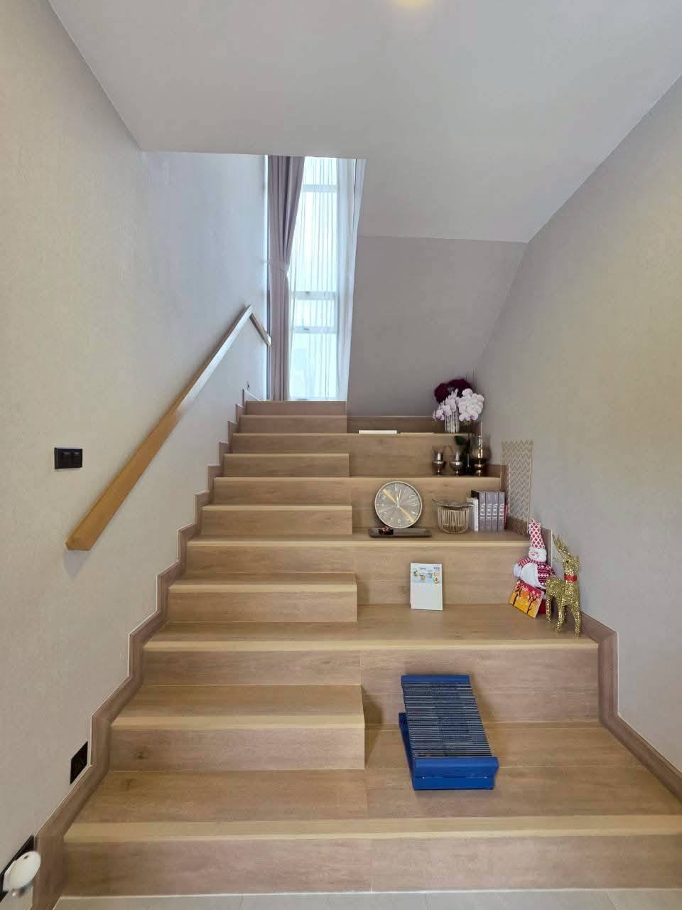 Wooden staircase with built-in storage shelves and decorative items displayed