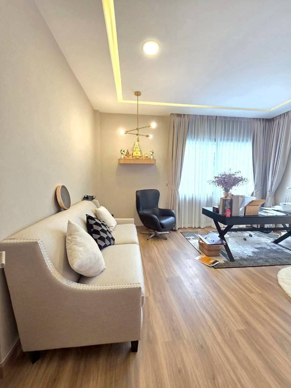 Modern luxury living room with cream sofa, wooden flooring, and contemporary furniture