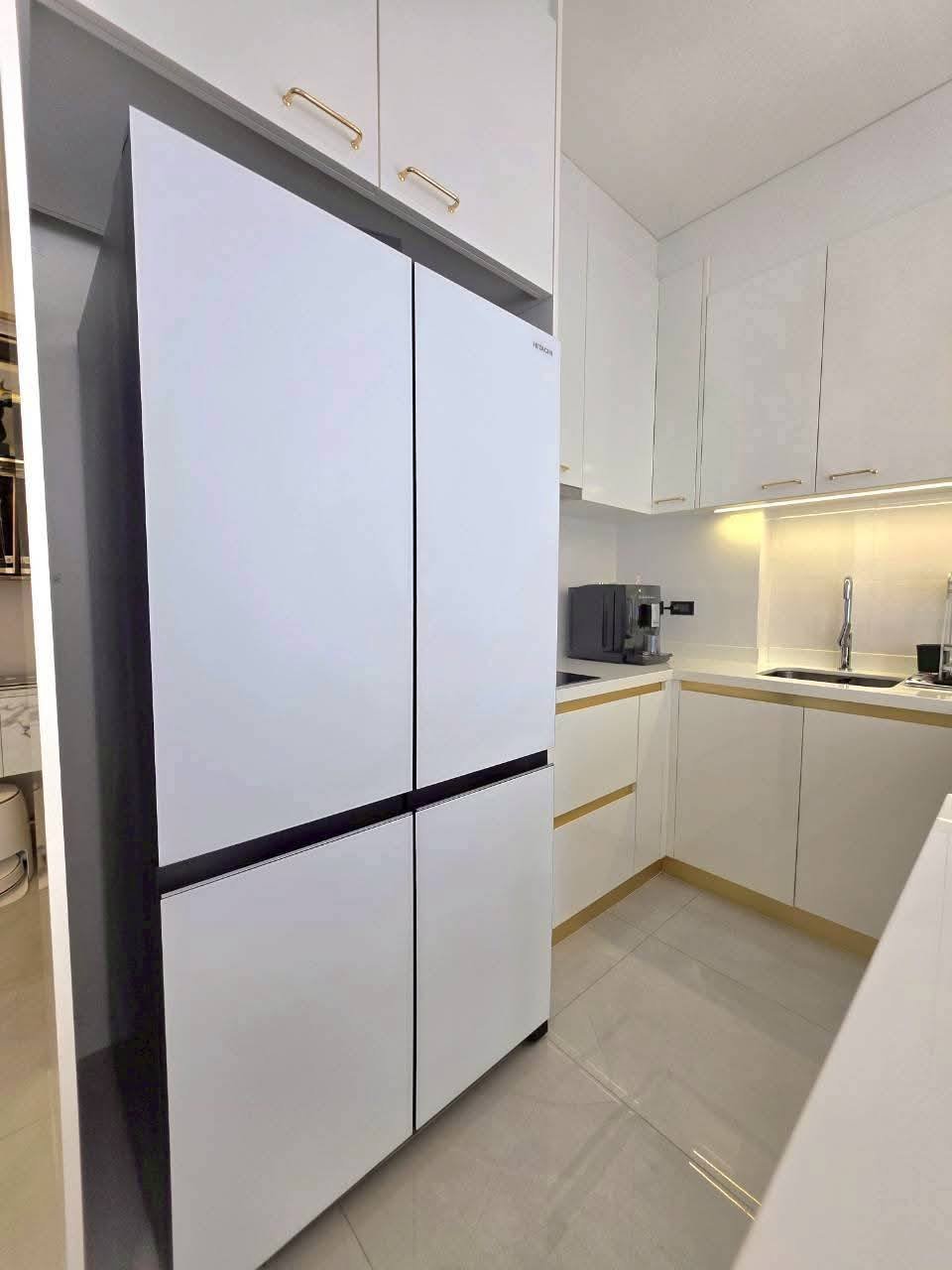 Modern white kitchen with refrigerator and wooden countertops