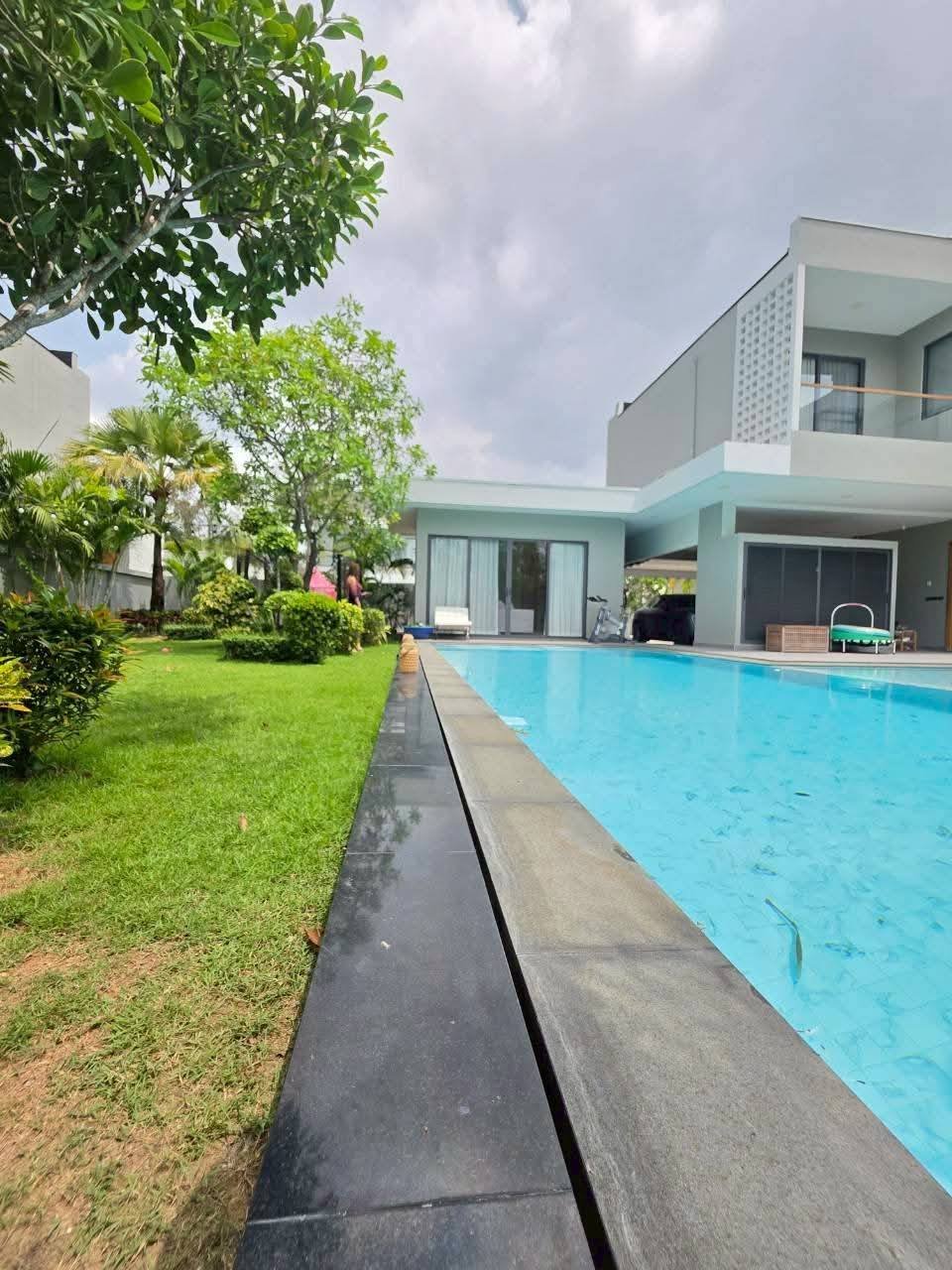 Modern house with swimming pool and manicured lawn garden