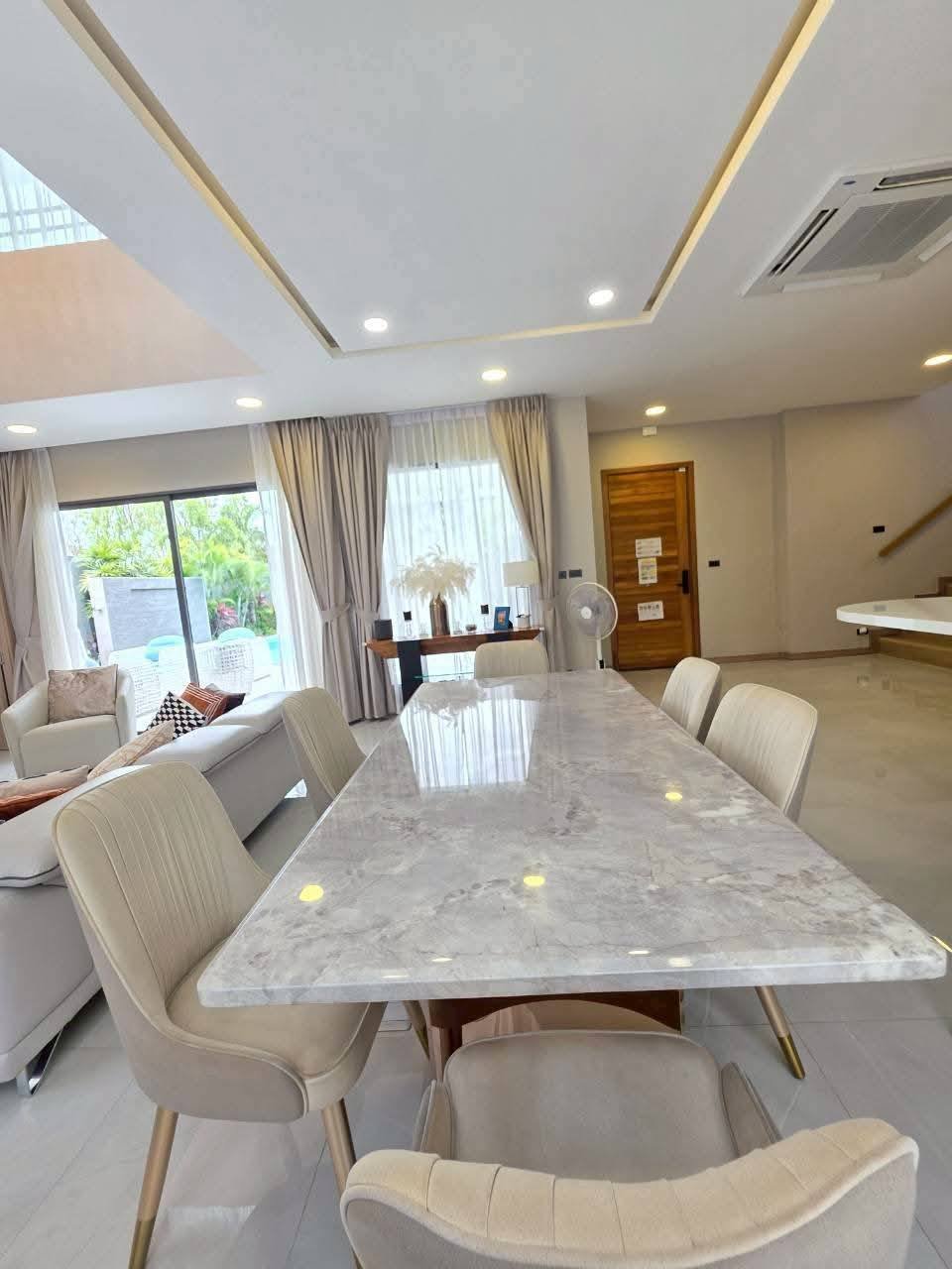 Modern luxury dining room with marble table and cream upholstered chairs